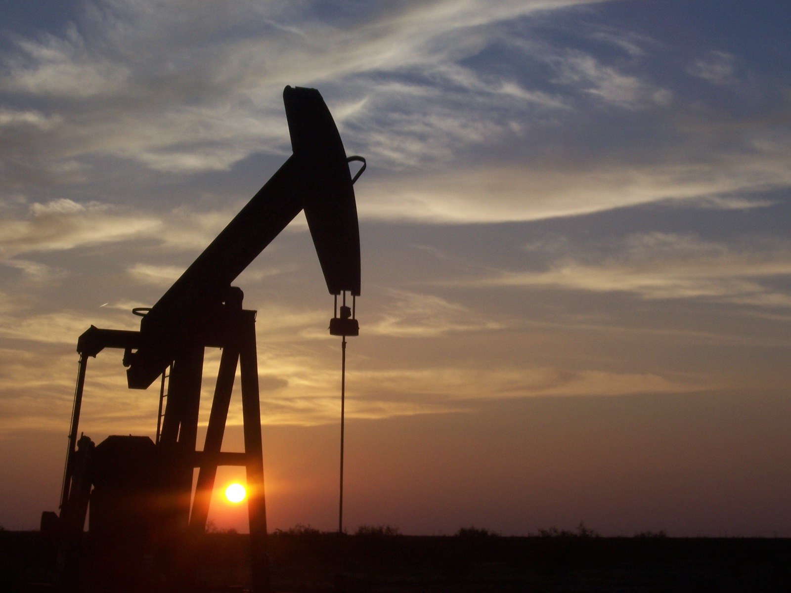 West Texas pumpjack at sunset - the Permian setting of the system